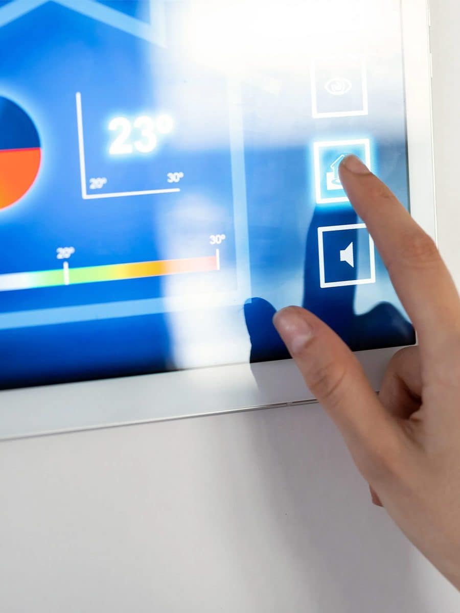 Young woman using the home automation system on digital tablet to regulate the temperature. Young woman using the home automation system on digital tablet to regulate the temperature.