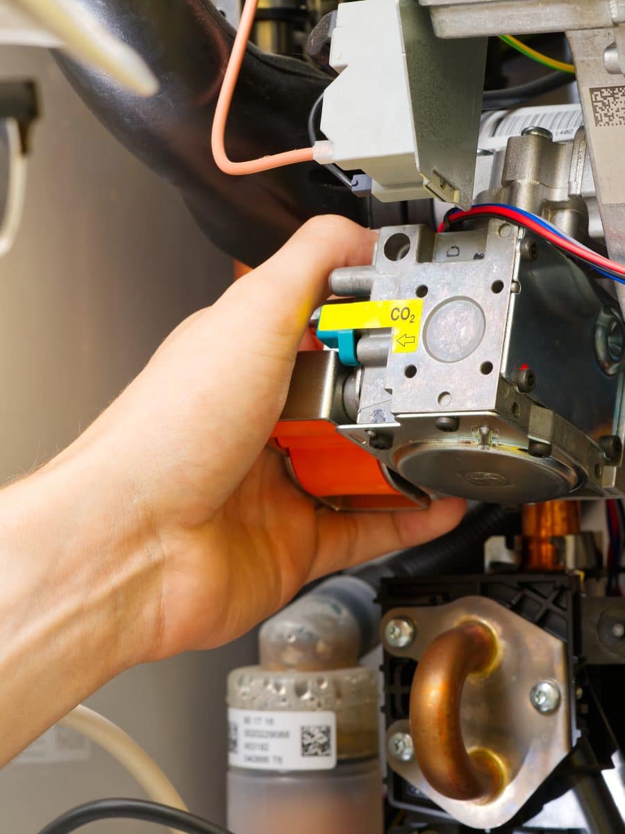Technician servicing or Repair of a gas boiler, setting up and servicing. gas boiler for heating Technician servicing or Repair of a gas boiler, setting up and servicing. gas boiler for heating